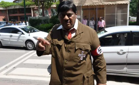Getty Images Naramalli Sivaprasad attends parliament dressed as Adolf Hitler on 9 August 2018 in Delhi.