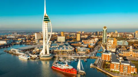 Aerial view of Portsmouth's spinnaker tower and harbour at sunrise