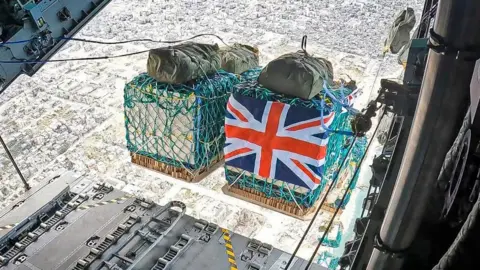 UK Ministry of Defence/ PA A view from inside an RAF plane shows humanitarian aid being airdropped over Gaza