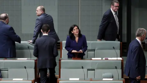 Alex Ellinghausen/Fairfax Media Julia Banks stands to speak in parliament as five male colleagues leave the chamber