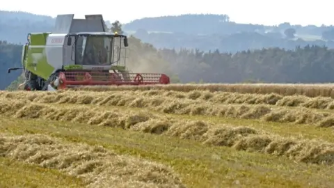 Owen Humphreys/PA Combine harvester in Cumbria