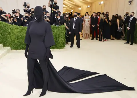 Getty Images Kim Kardashian dressed in an all-enveloping black outfit that also covers her face