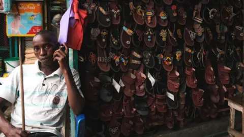 AFP A man listen the news on his phone in downtown Bujumbura after Security minister Gervais Ndirakobuca is appointed as the new Burundi Prime Minister in Bujumbura on September 7, 2022.