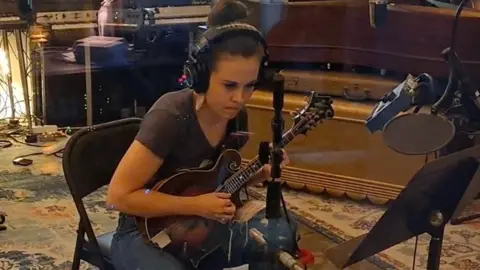 Family Handout Sierra Hull playing the mandolin