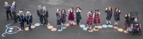 PA Media (left to right) Connor and John Branchfield, Alice and Penny Beer, Ben and Josh Cairns, Stuart and Emily Miller, Malena and Lola Perez, Aria and Isla McLaughlin, Eva and Iona Metcalfe and Lianna and Kali Ptolomey, eight sets of twins from the Inverclyde area, pose for a photograph ahead of their first day at school.