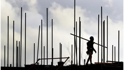 PA Media Construction worker building houses