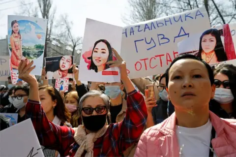 Reuters People hold placards during a rally in front of Kyrgyzstan's interior ministry after the murder of Aizada Kanatbekova