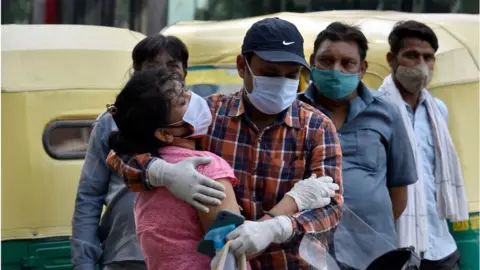 Getty Images A woman being consoled after the hospital turned away her father from admission into the Covid-19 ward