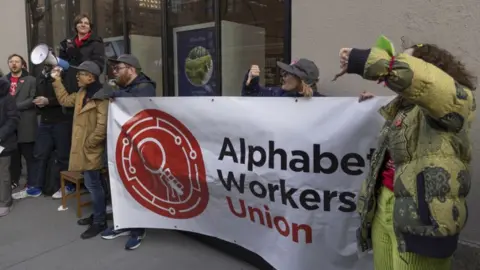 Getty Images A group of people protesting outside a building