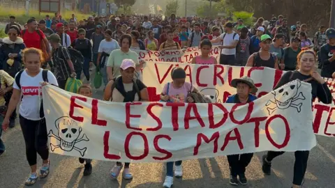 Getty Images Migrants from Central and South America take part in a caravan attempting to reach the Mexico-US border, while carrying out a viacrucis to protest for the death of 40 migrants in a fire at a detention center in the northern city of Juarez, in Tapachula, Chiapas state, southern Mexico, on April 23, 2023.