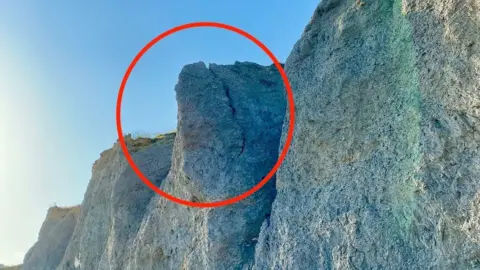 West Bay Coastguard Rescue Crack in the cliff at Seatown Beach