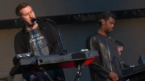 Getty Images Members of Massive Attack performing on stage