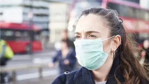 Getty Images Woman wearing face mask