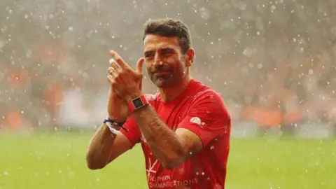 PA Francis Benali applauded by crowd after run
