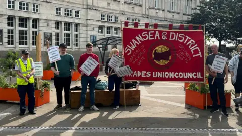 rail workers striking outside Swansea station