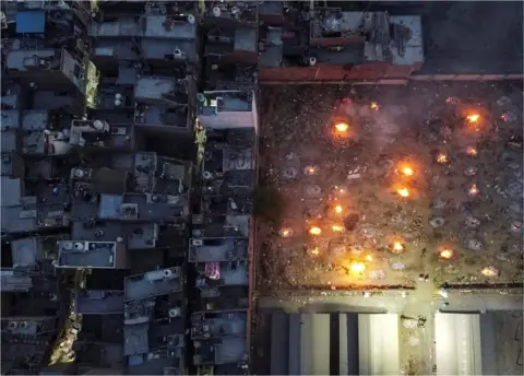 Danish Siddiqui / Reuters An aerial view of cremations in New Delhi, India