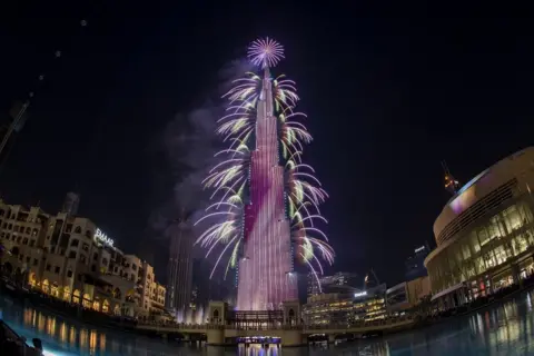 Getty Images Fireworks on the Burj Khalifa tower in Dubai during the new year's eve celebrations on December 31, 2020.
