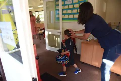 Mother sends child into classroom