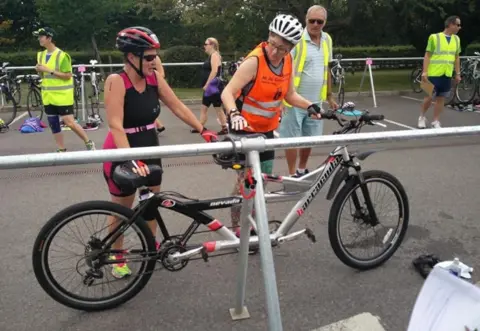 Helen McCann Helen McCann standing by a tandem