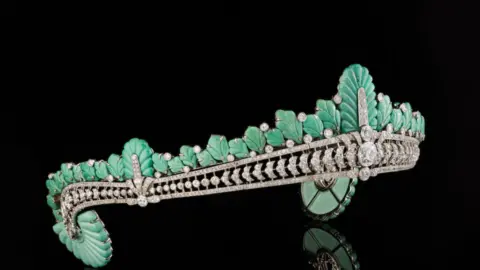 The tiara from the side showing the turquoise plumage and large diamond at the centre.
