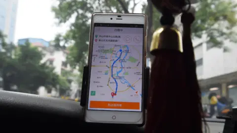 Getty Images A taxi driver using the Didi Chuxing app in Guilin, China