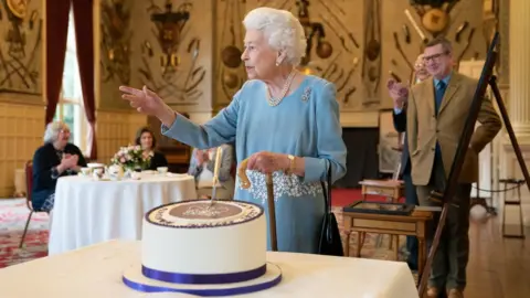 PA Media Queen Elizabeth II with celebration cake