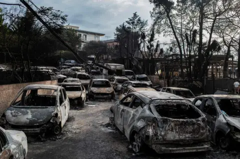 AFP This photo show cars burnt following a wildfire at the village of Mati.