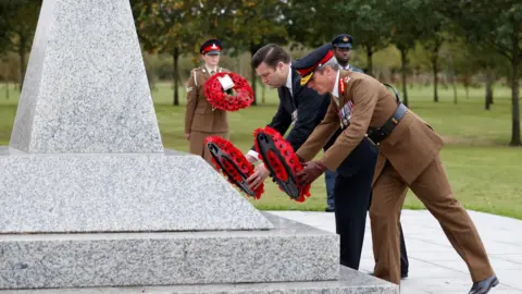 Reuters Armed Forces minister James Heappey and Major General Gerald Strickland lay wreaths during the service in Staffordshire