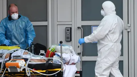 AFP Healthworkers taking a patient into hospital