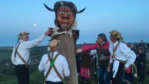 BBC Wessex Morris Men welcome the May Day sunrise by the Cerne Abbas giant, Dorset