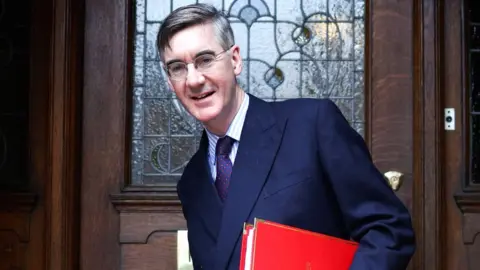 Reuters Jacob Rees-Mogg leaves a home in London