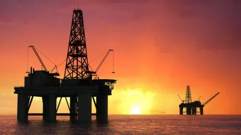 Getty Images Silhouette oil rig.