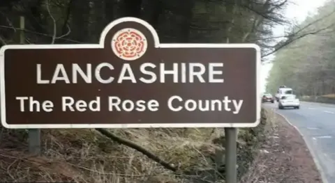 Chris Pearson/Geograph A sign marking the border with Lancashire "the Red Rose County"