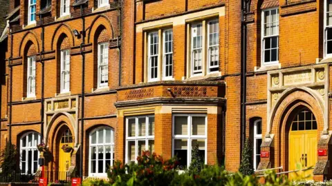 An exterior shot of a red brick building at Kent College in Canterbury
