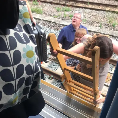 Lily Winnan Passengers disembarked a train near Kentish Town station and began walking along the tracks