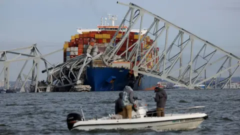 Reuters Boaters observe the site of the boat crash