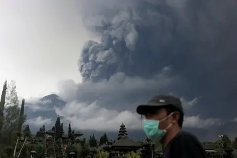 Reuters Mount Agung volcano erupts as seen from Besakih Temple in Karangasem, Bali, Indonesia on 26 November 2017.