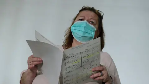 Getty Images Singer in a face mask