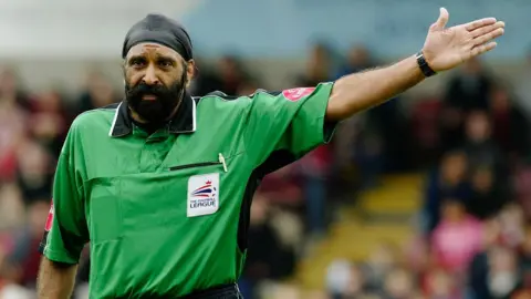 Getty Images Jarnail officiating in a green shirt