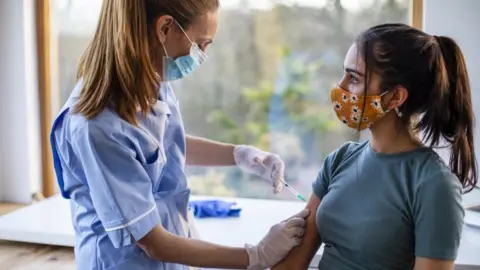 Getty Images A nurse giving a teenager a Covid vaccine