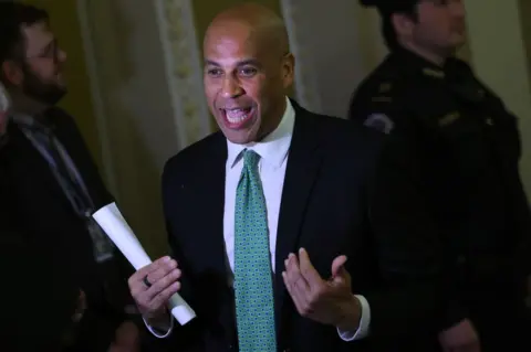 Getty Images Senator Cory Booker gesticulates while holding a piece of paper at the US Capitol on 2 March, 2023