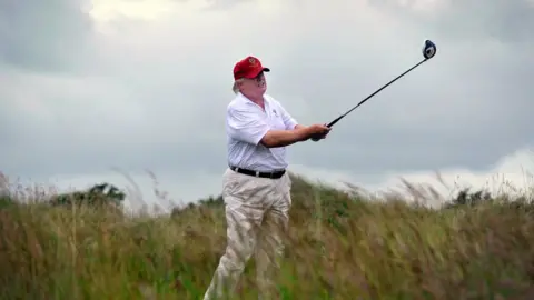 iStock Donald Trump on the golf course.