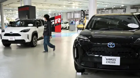 Getty Images A person at a Toyota showroom in Tokyo.