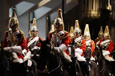 Jordan Pettitt / PA Wire Mounted troops take part in a night time rehearsal in central London for the Coronation.