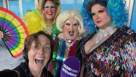 BBC BBC Radio Wiltshire's Kelly Morgan pictured with three drag queens