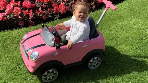 Jay Watson Willow in a Mini pedal car