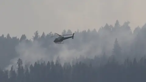 Reuters A helicopter flies over a wildfire south west of the town of Cache Creek, British Columbia, Canada July 18, 2017