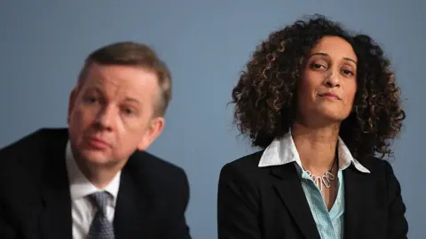 Getty Images A file image of Katherine Birbalsingh sitting next to Michael Gove at an event