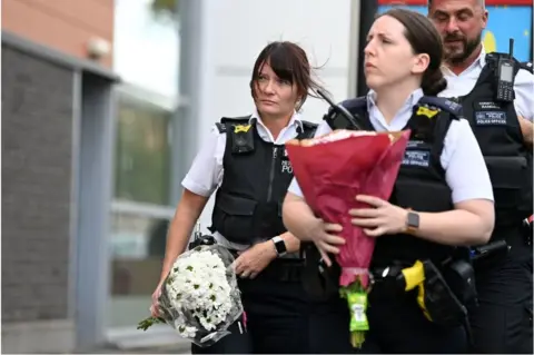 Getty Images police with flowers