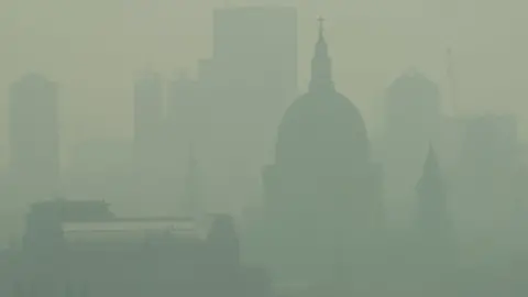 LEON NEAL Mist and pollution hang over the London skyline